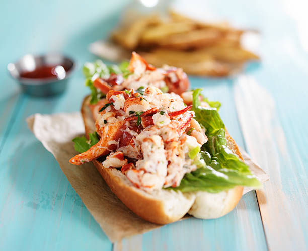 lobster roll on colorful retro painted wooden planks lobster roll on colorful retro painted wooden planks shot close up lobster seafood photos stock pictures, royalty-free photos & images