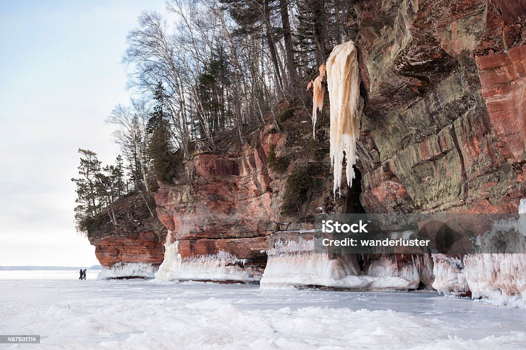 Exploring the remote Apostle Island ice caves in Wisconsin Sandstone cliffs with giant icicles and ice caves at Apostle Island National Lakeshore, Cornucopia, Bayfield County, Wisconsin, USA Apostle Islands - Wisconsin Stock Photo
