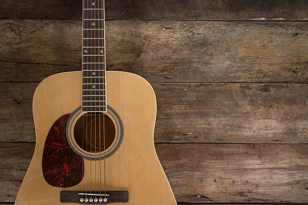 istock Top view of guitar on dark wood floor texture 487501142
