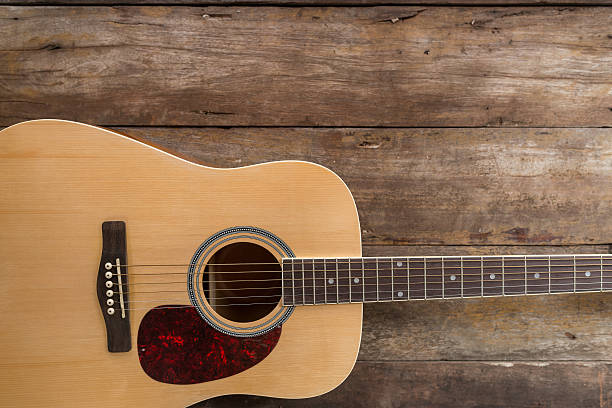 istock Top view of guitar on dark wood floor texture 487501144
