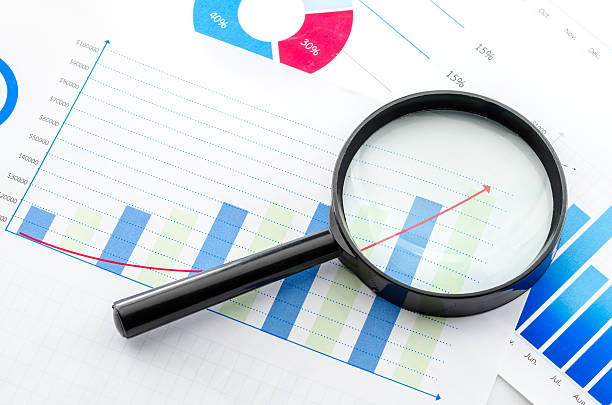 istock Magnifying glass on financial charts and graphs 487506130