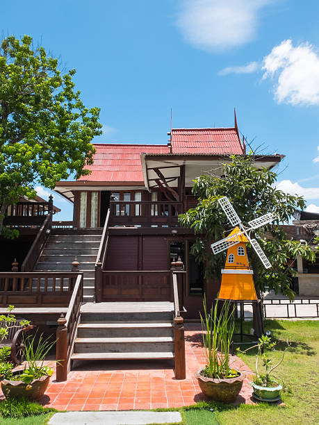 istock Ancient Thai House style with windmill vertical 487506634