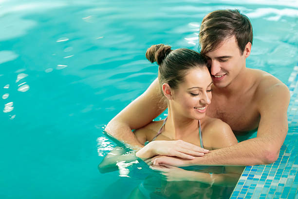 istock Young couple in the swimming pool 487509101