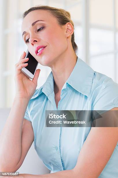 Serious Businesswoman Using Mobile Phone Stock Photo - Download Image Now - 30-39 Years, 35-39 Years, Adult