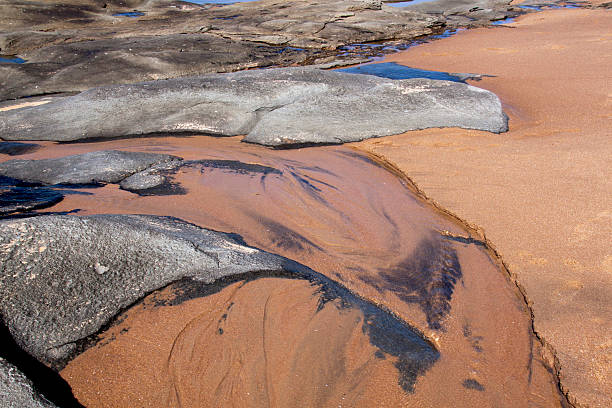 istock Patterns in Sand and Rocks at Low Tide on Shoreline 487511971