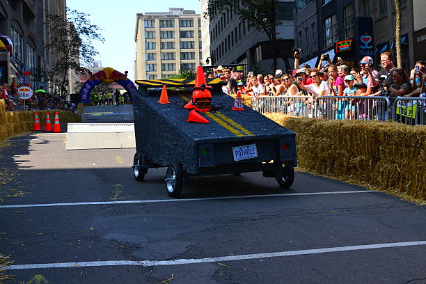 Montreal Red Bull Soapboax Race Montreal, Canada - September 06, 2015: Montreal Red Bull Soapboax Race in Montreal Downtow.A lot of fun and ingenious ideas.Number 17-Pothole team. red bull mini stock pictures, royalty-free photos & images