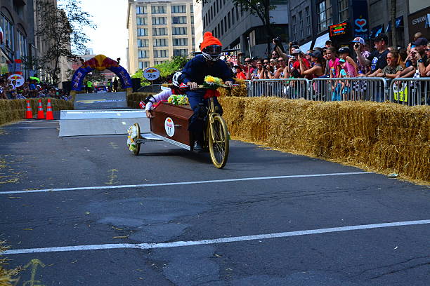 Montreal Red Bull Soapbox Race Montreal, Canada - September 06, 2015: Montreal Red Bull Soapbox Race in Montreal Downtown.A lot of fun and ingenious ideas.Number 21-Coffin team. red bull mini stock pictures, royalty-free photos & images
