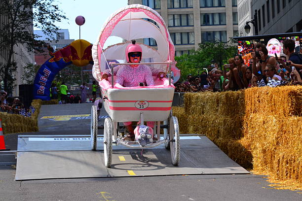 Montreal Red Bull Soapbox Race Montreal, Canada - September 06, 2015: Montreal Red Bull Soapbox Race in Montreal Downtown.A lot of fun and ingenious ideas.Number 35-Baby team. red bull mini stock pictures, royalty-free photos & images