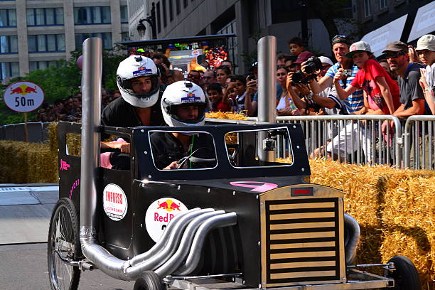 Montreal Red Bull Soapbox Race Montreal, Canada - September 06, 2015: Montreal Red Bull Soapbox Race in Montreal Downtown.A lot of fun and ingenious ideas.Number 36-Cancer du sen Quebec team. red bull mini stock pictures, royalty-free photos & images
