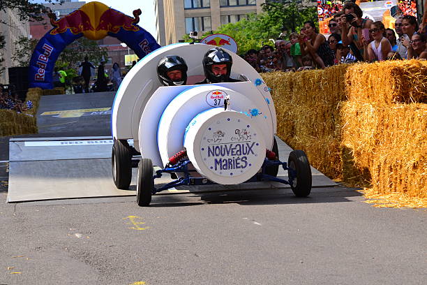 Montreal Red Bull Soapbox Race Montreal, Canada - September 06, 2015: Montreal Red Bull Soapbox Race in Montreal Downtown.A lot of fun and ingenious ideas.Number 37-Nouveaux maries Quebec team. red bull mini stock pictures, royalty-free photos & images