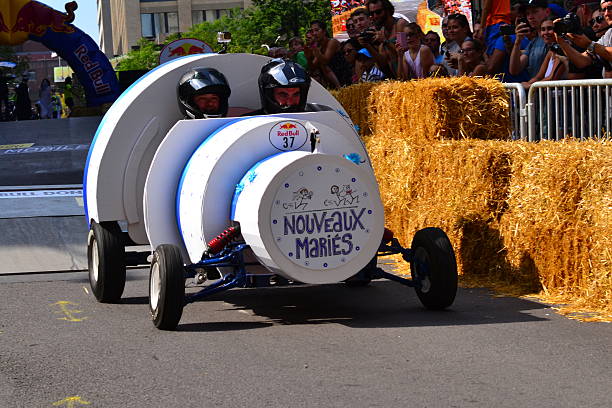 Montreal Red Bull Soapbox Race Montreal, Canada - September 06, 2015: Montreal Red Bull Soapbox Race in Montreal Downtown.A lot of fun and ingenious ideas.Number 37-Nouveaux maries Quebec team. red bull mini stock pictures, royalty-free photos & images