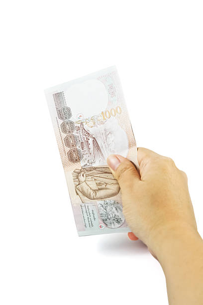 istock Hand holding Thailand money bills 487512518