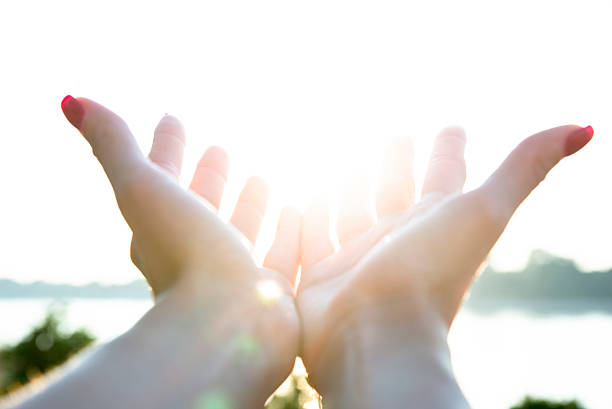 istock beautiful female hands and the sun 487515244