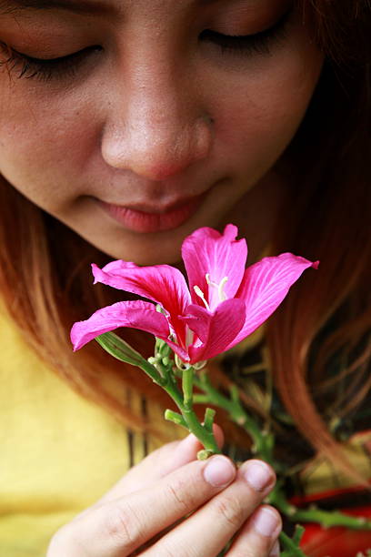 istock young woman smelling pink flowers 487515292