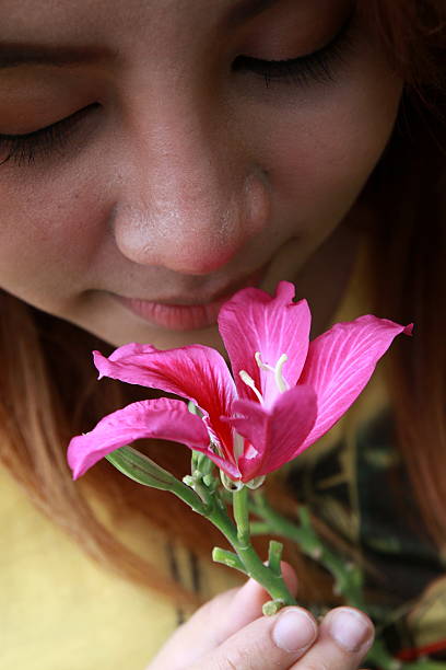 istock young woman smelling pink flowers 487515382