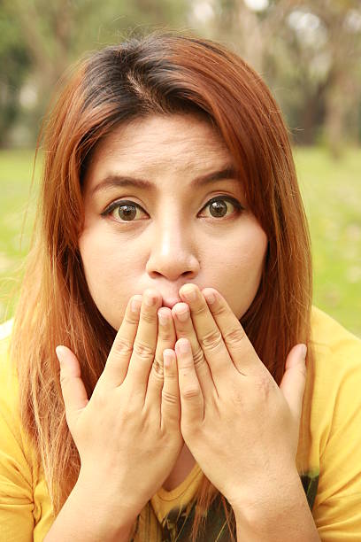 istock Young Asian woman close her mouth 487515456