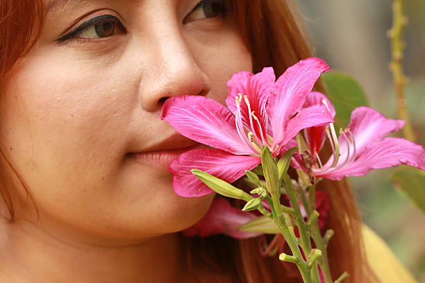 istock young woman smelling pink flowers 487516216