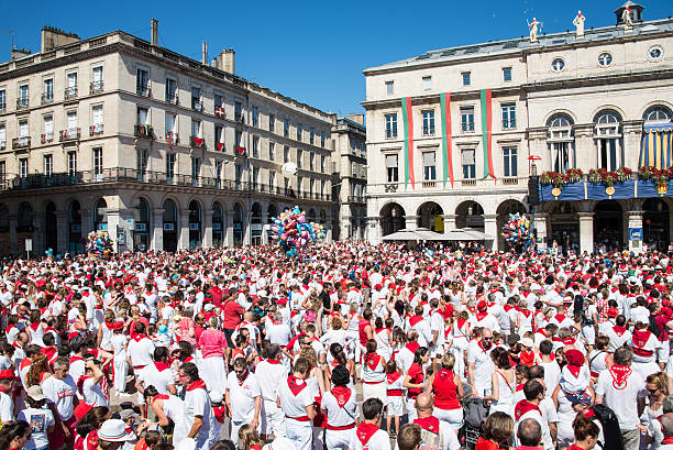 People at the Summer festival of Bayonne Bayonne, France - August 2, 2015: Crowd of people dressed in white and red at the Summer festival of Bayonne (Fetes de Bayonne), France bayonne stock pictures, royalty-free photos & images
