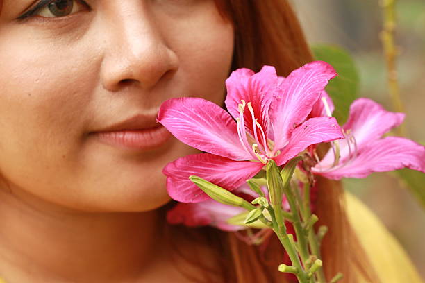 istock young woman smelling pink flowers 487519620