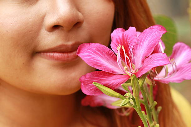 istock young woman smelling pink flowers 487519646