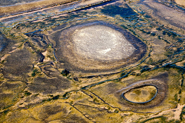 istock Circular and Square Erosion Patterns in Slimy Seashore Rock Pool 487520691