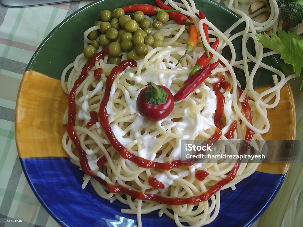 pasta plate plate of pasta or spaghetti with vegetables,spaghetti in plate on table and spoon and fork Basil Stock Photo