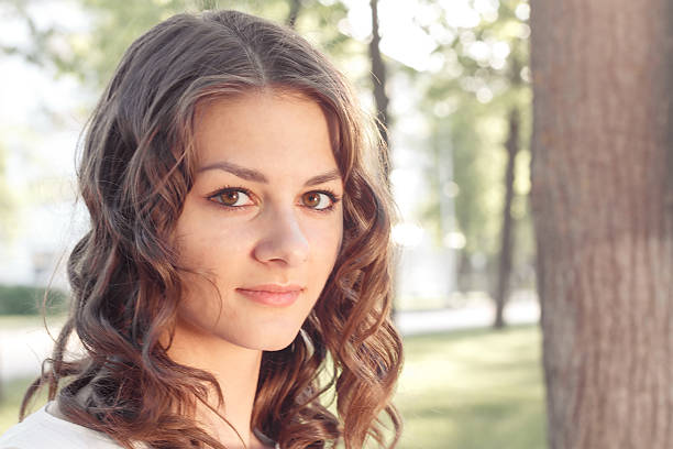 istock beautiful young attractive girl with a flower at sunset 487521940