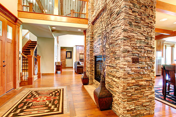istock Luxury house interior. Stone wall with fireplace 487521997