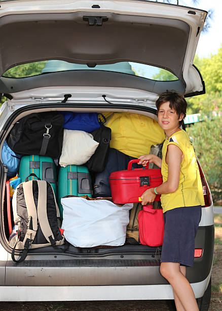 istock child loads bags in the baggage car in summer 487522310