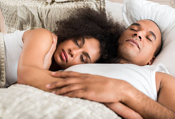 istock Embraced African American couple sleeping in bed. 487526406