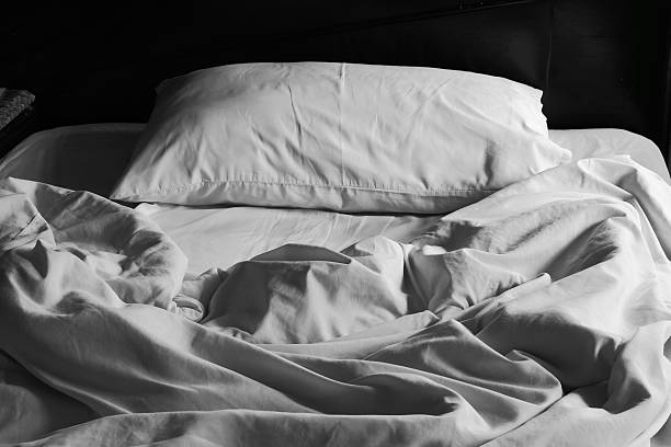 istock Messy white bed and pillow, in the morning 487526858