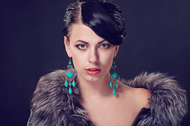 istock Young woman in a fur coat in  earrings 487527207