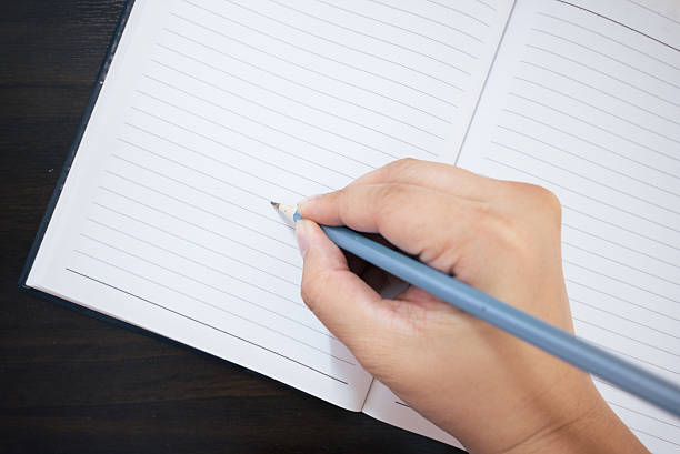 istock Blank paper and hand with pencil 487527585