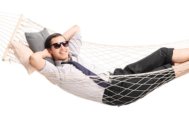 istock Carefree young businessman lying in a hammock 487530512