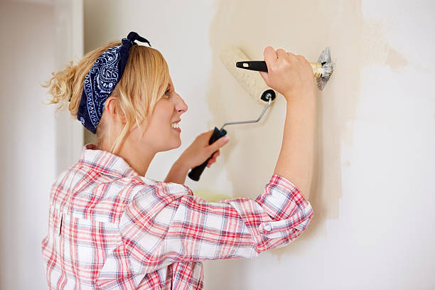 istock Young woman having fun while painting 487533901