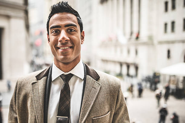 istock Smiling businessman on wall street 487534011