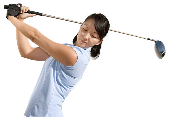 Young Asian woman swinging driver isolated on white background.