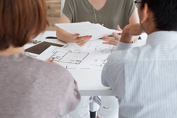 istock Real estate agent to explain the design plan to couple 487535244