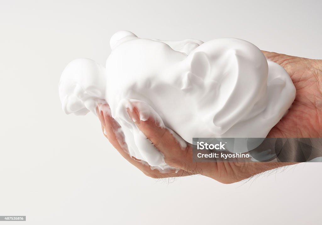 Isolated shot of hand with shaving cream against white background Close-up of hand with shaving cream against white background. Soap Sud Stock Photo