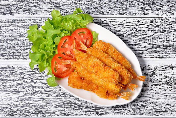 istock Fried shrimp on wooden background. 487537658