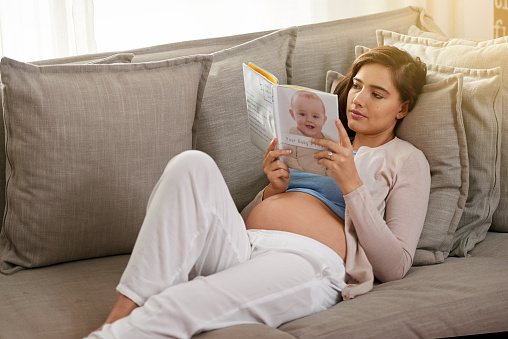 Shot of a young pregnant woman reading a baby book at homehttp://195.154.178.81/DATA/i_collage/pi/shoots/805501.jpg