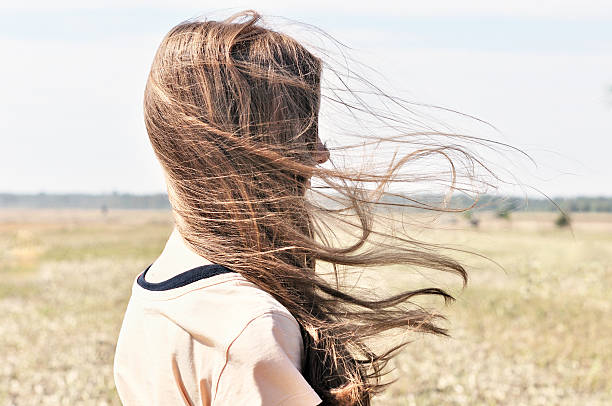 Wind flutters young girls hair stock photo