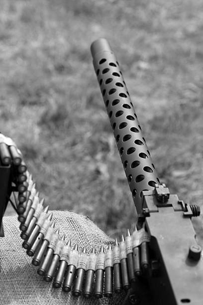 istock big machine gun with bullets over the sandbags 487538208