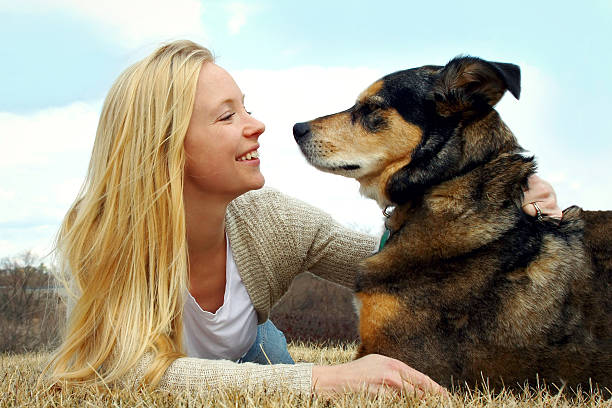 istock Woman Petting her German Shepherd Dog Outside 487538515