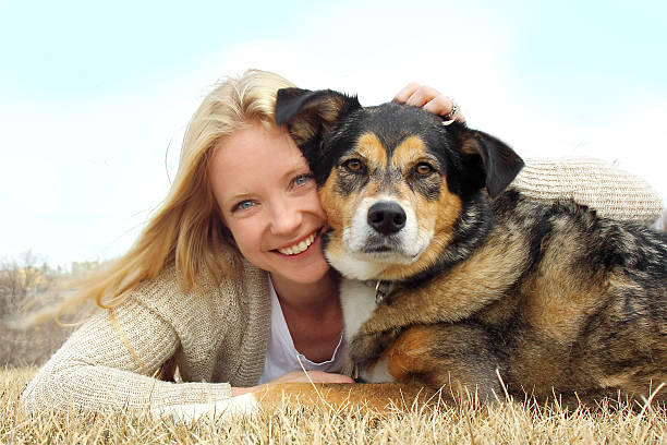 istock Smiling Woman Hugging German Shepherd Dog 487538523
