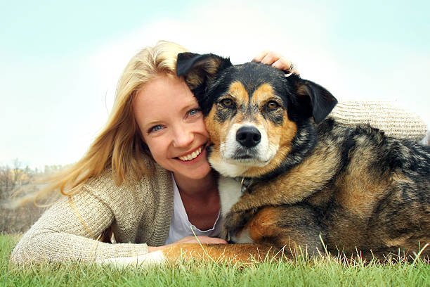 istock Smiling Woman Hugging German Shepherd Dog 487538545