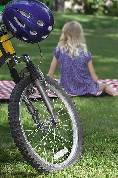 Picnic recreation after bike riding on a blanket in the park
