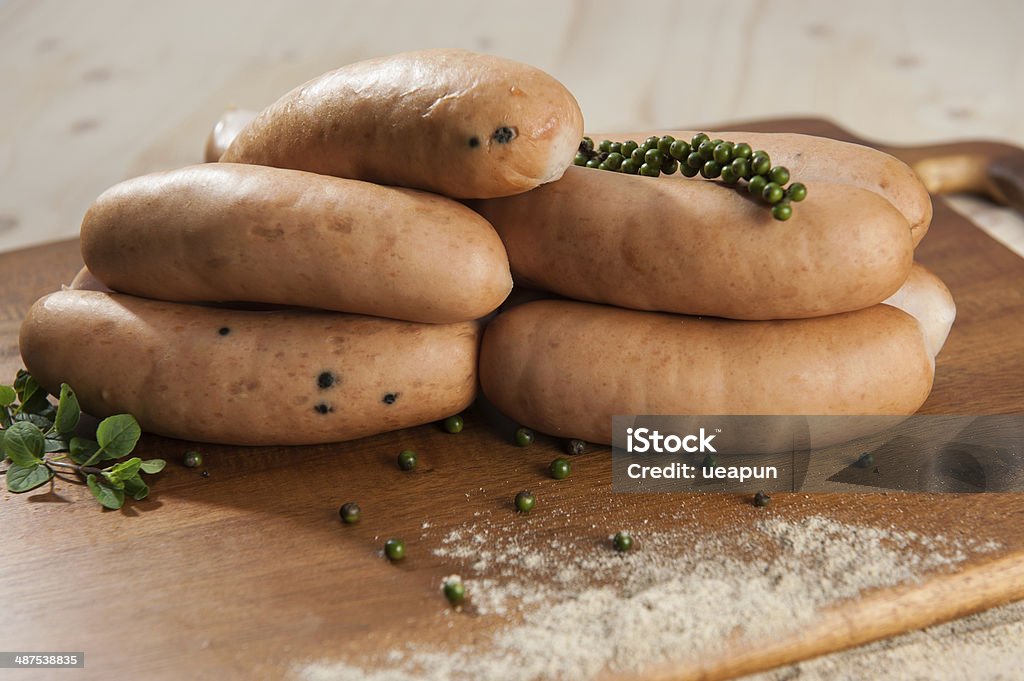 Pepper sausages Pepper sausages on wooden cutting board Close-up Stock Photo