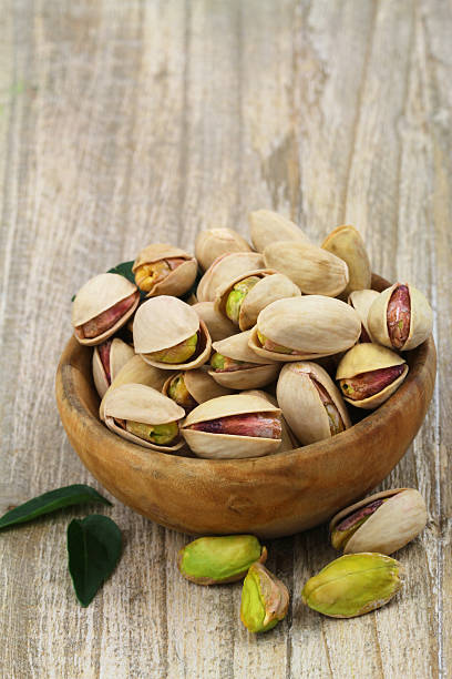 istock Pistachios in wooden bowl with copy space 487538939