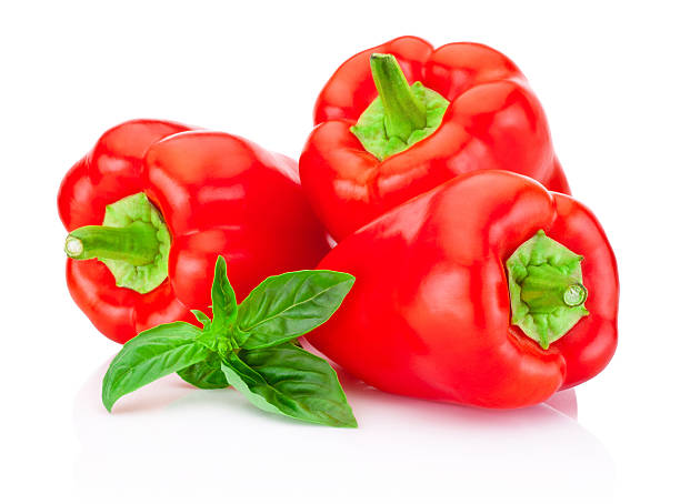 istock Three bell Red Peppers with green leaves basil isolated+ 487543682
